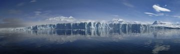 A large body of water with a mountain in the background.