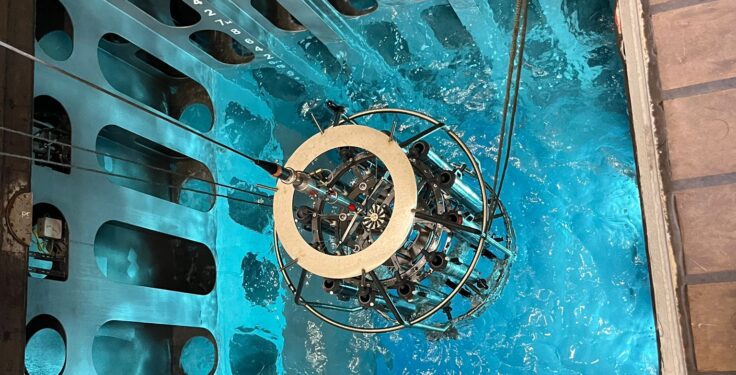 Scientific instrument being lowered into the moonpool.