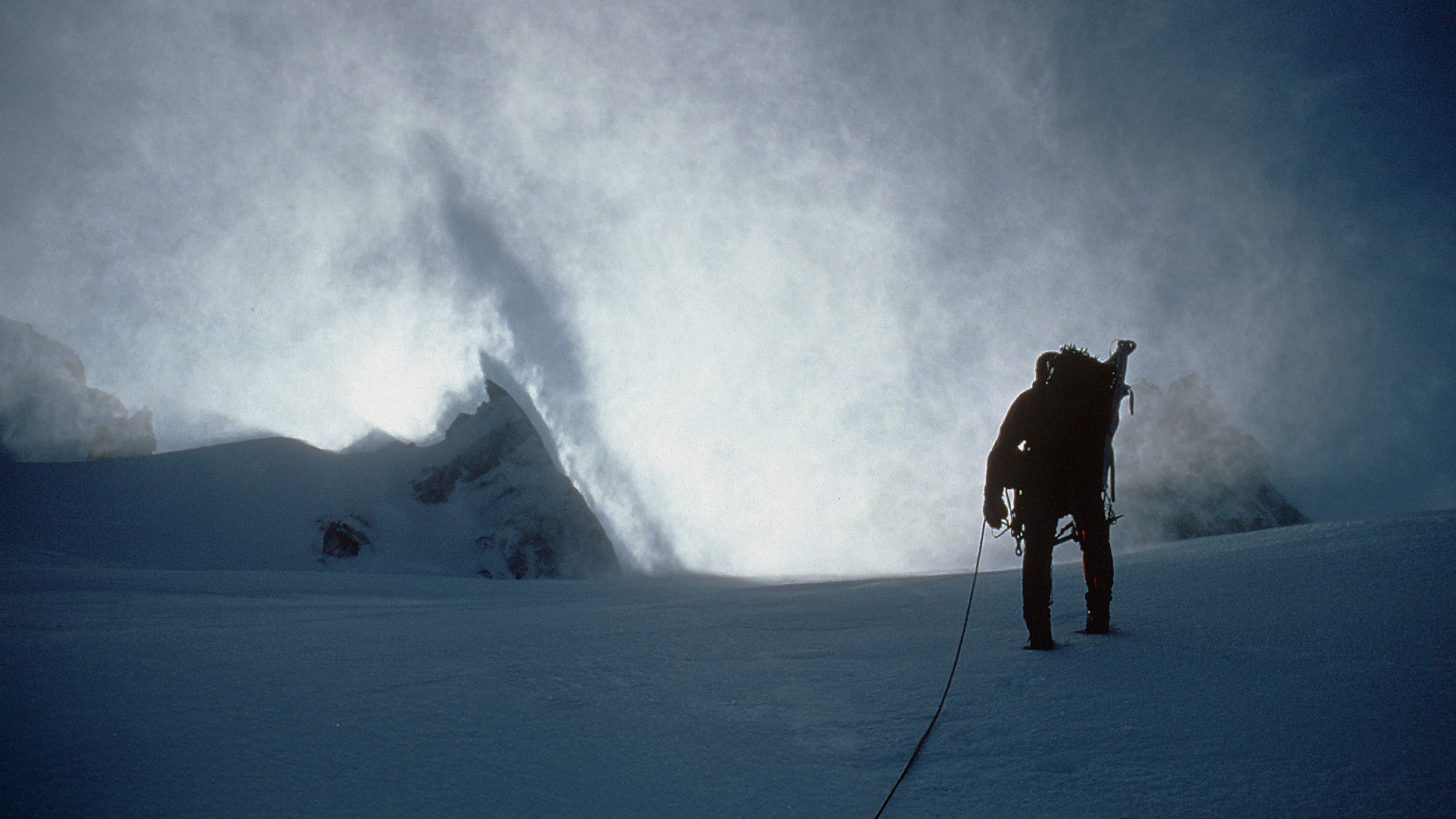 A man riding skis down a snow covered slope