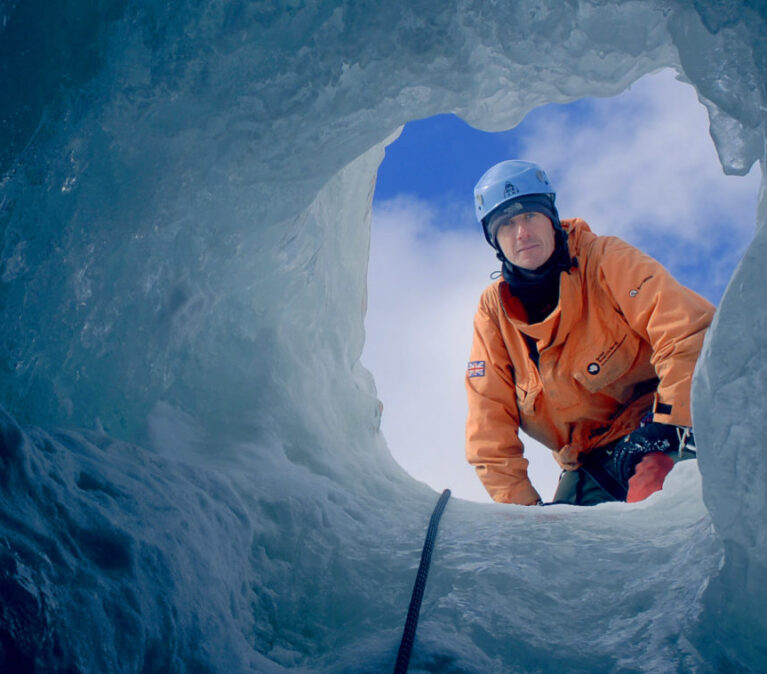 Looking up to a BAS Field assistant through a deep hole in the ice