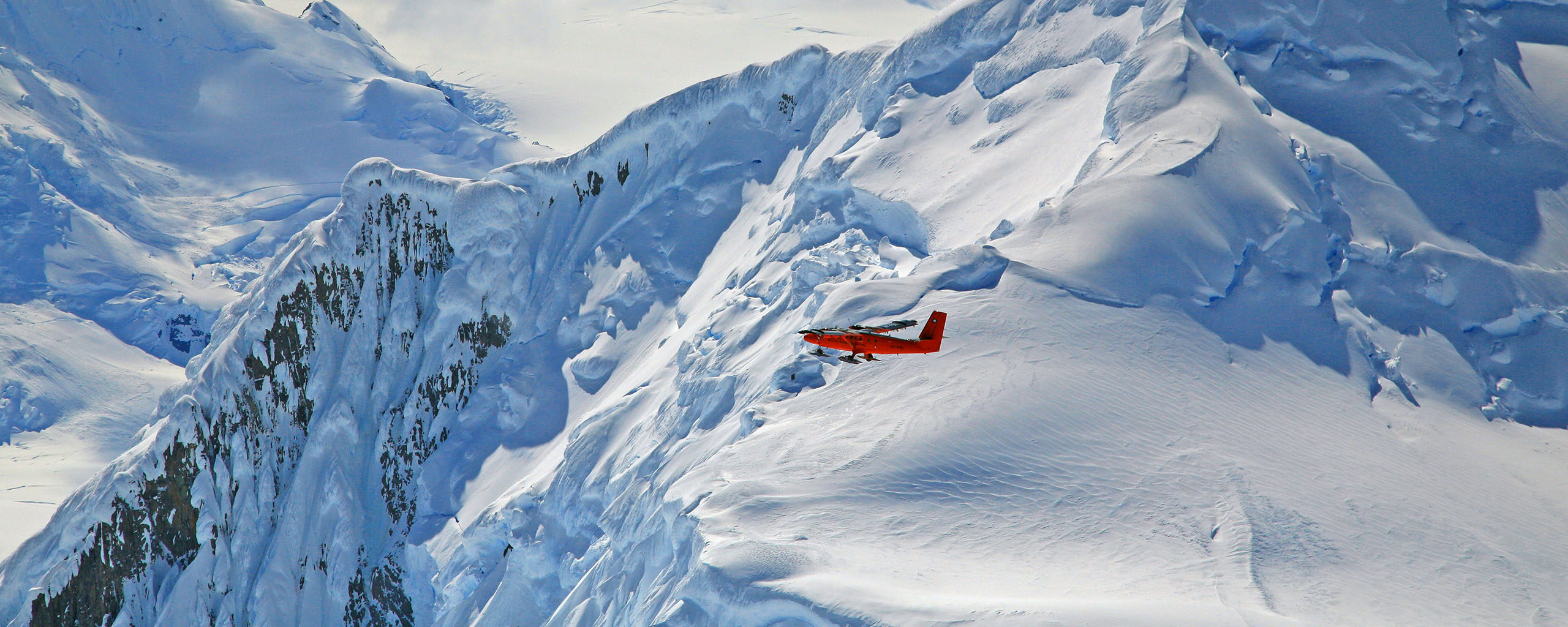 A man standing on top of a snow covered mountain