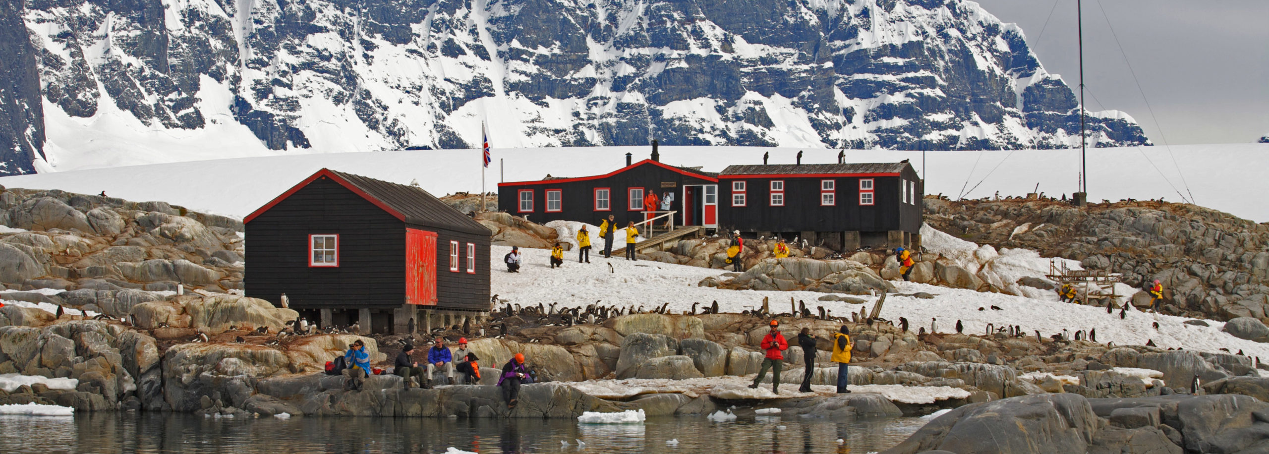 A group of people standing on top of a snow covered mountain.