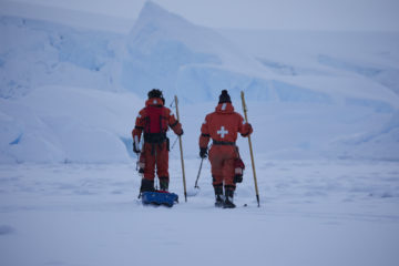 Two people cross country skiing in the snow