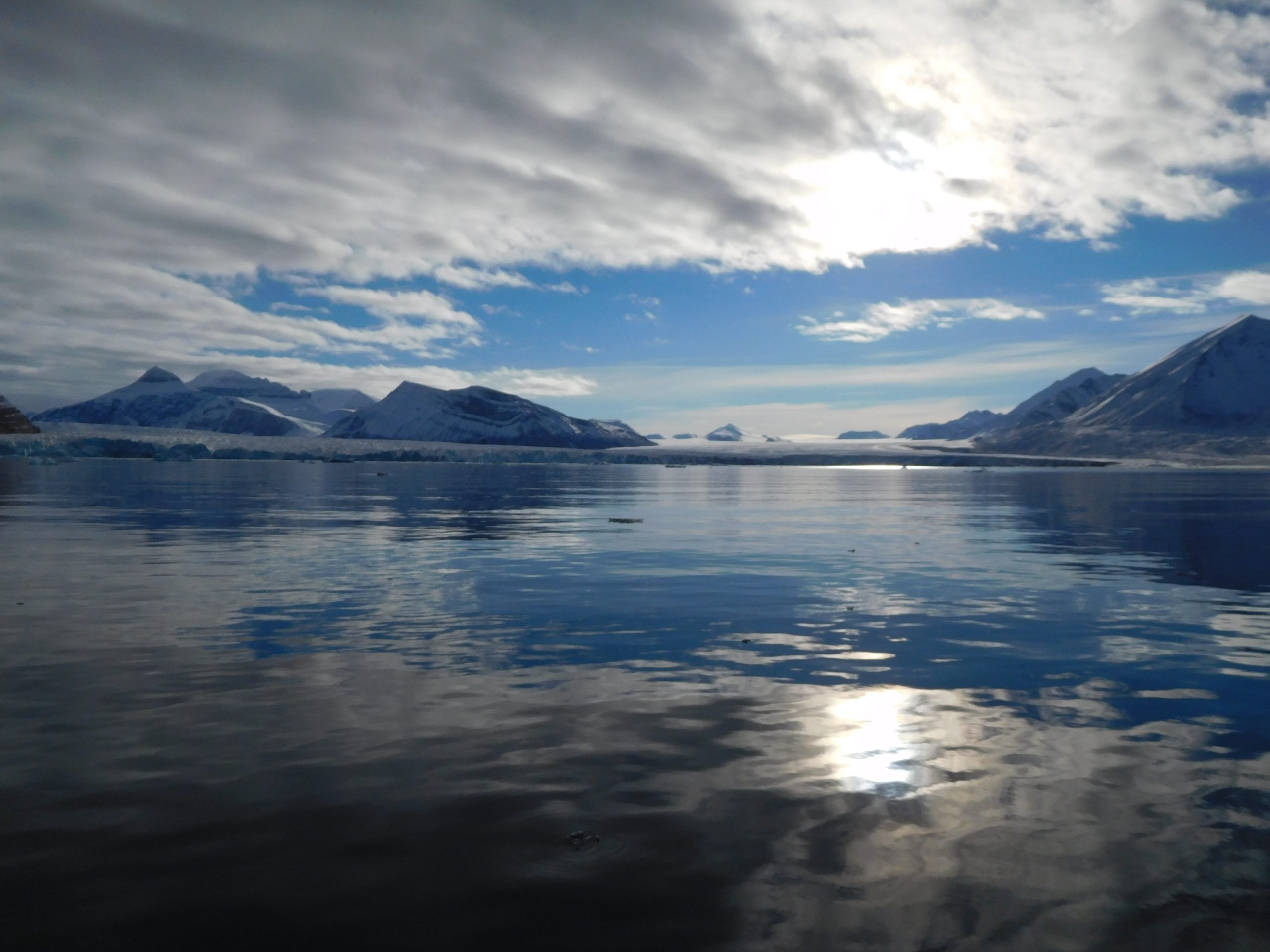 A body of water with a mountain in the background.