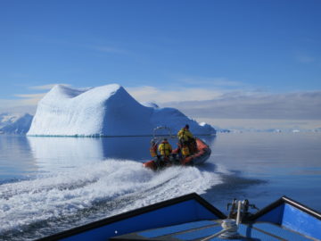 A group of people in a boat on a body of water.