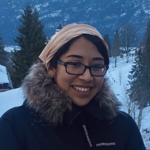 A person wearing glasses and smiling at the camera