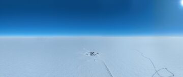A snowy landscape with blue sky