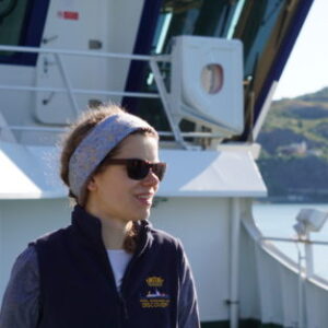 A person standing in front of a boat