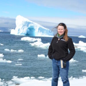 A person standing on a snow covered mountain.
