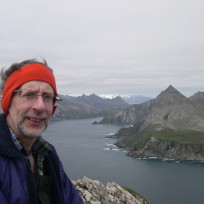 A person standing next to a body of water.