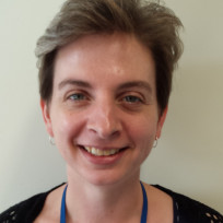 A woman smiling for the camera.