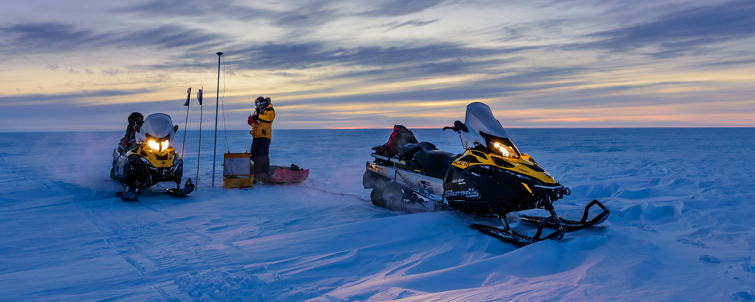 A pair of skidoos working in the deep Antarctic field.