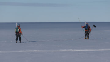 A man is cross country skiing in the water
