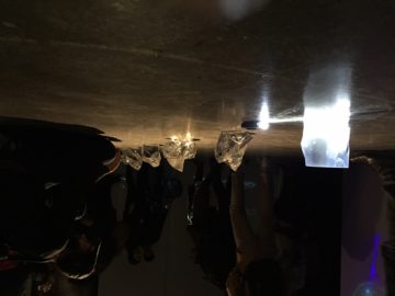 A group of people that are standing in the dark.