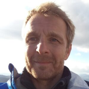 A close up of a man smiling for the camera