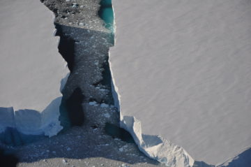 A man flying through the air on a rock.