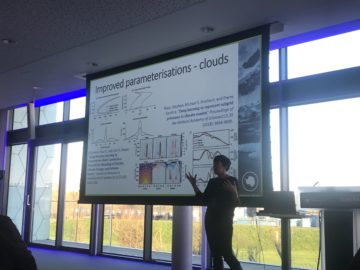 A group of people standing in front of a window.