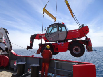 A group of people on a boat in the water.