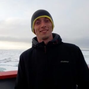 A man standing next to a body of water