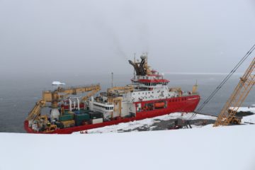 A boat that is sitting in the snow