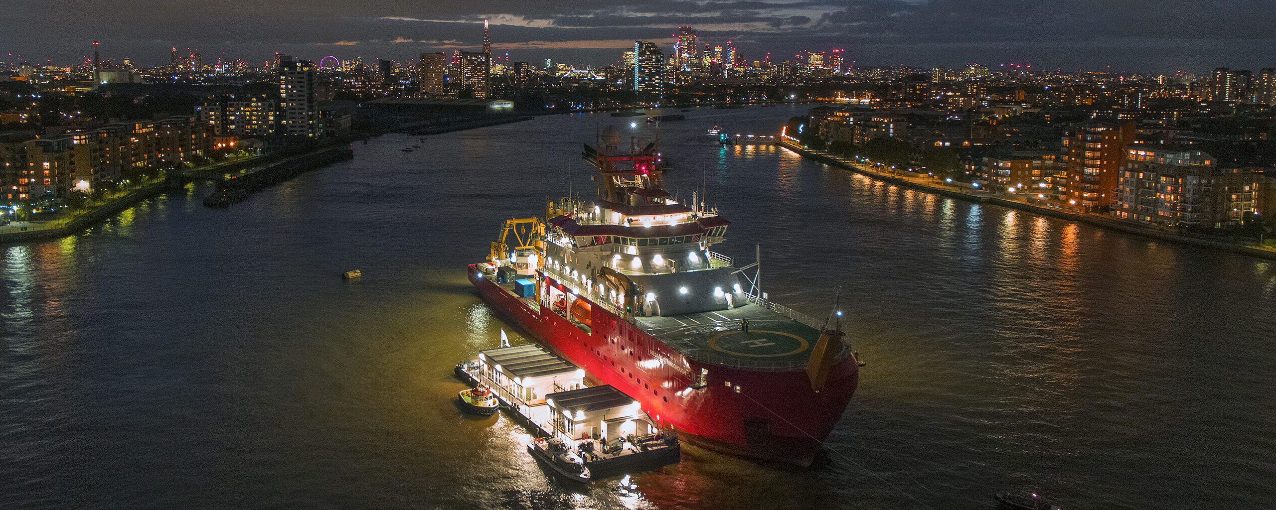 RRS Sir David Attenborough photographed at night in London on the Thames river.