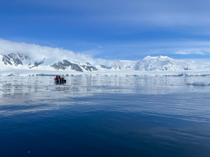 A group of people standing on top of a snow covered mountain