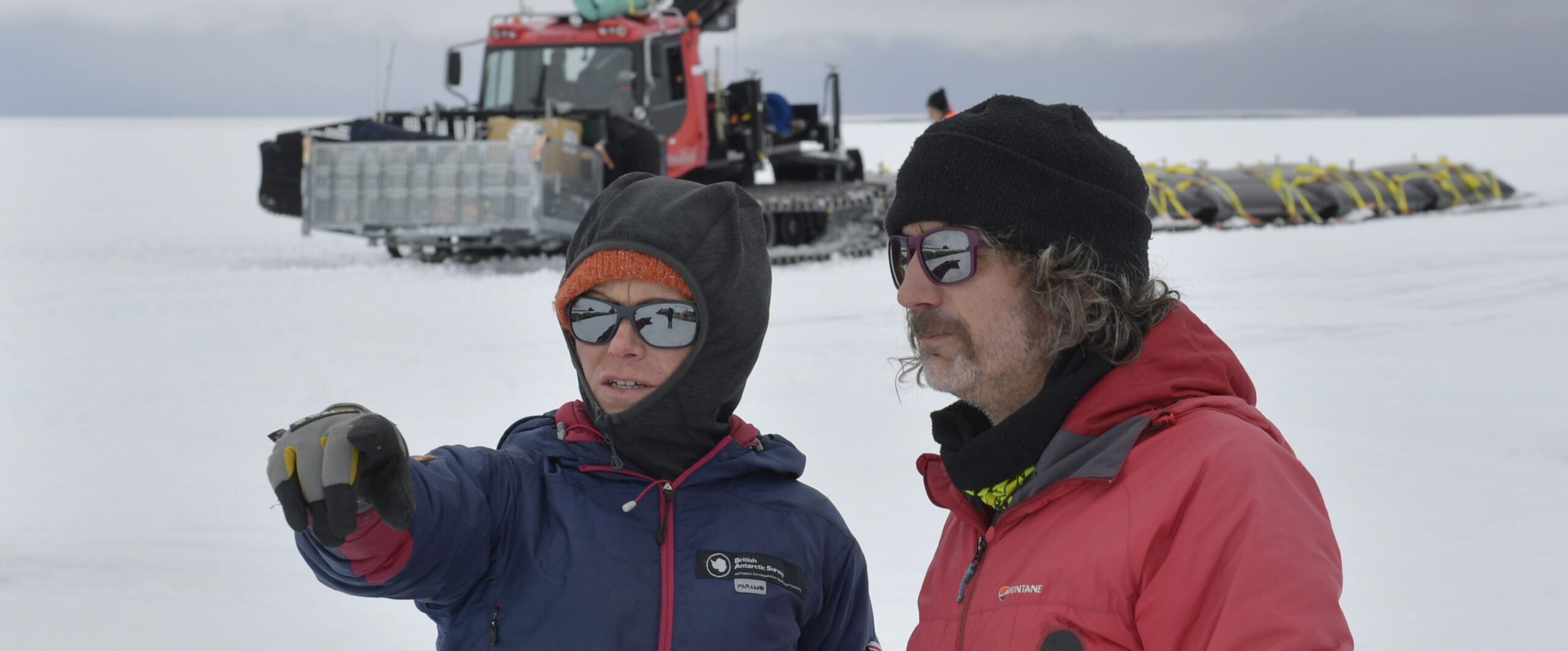 A couple of people that are standing in the snow