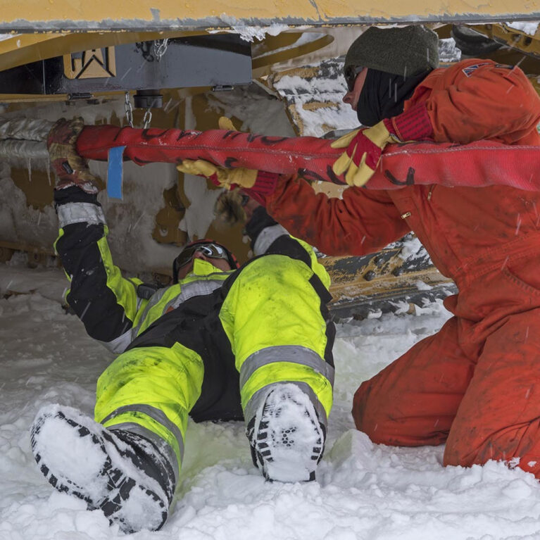 A person lying on a pile of snow