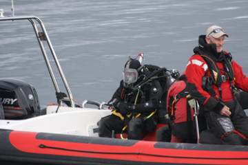 A group of people riding on the back of a boat