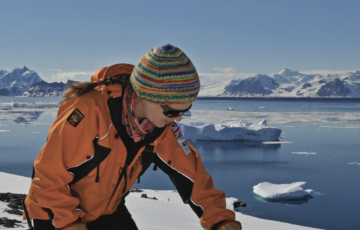 Cleaning the All-Sky Camera portal on top of the optical caboose at Rothera Research Station